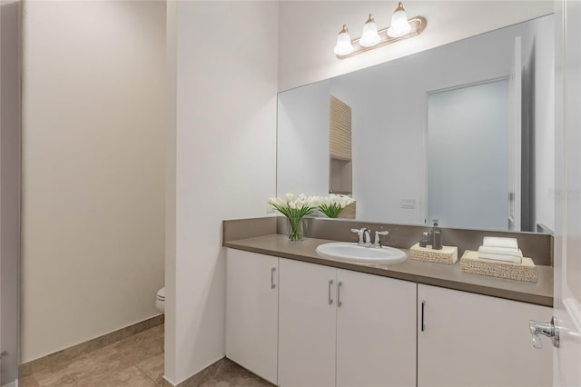 bathroom featuring vanity and toilet