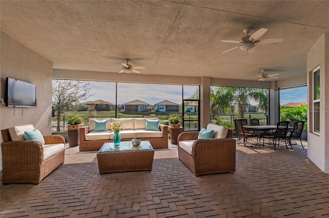 view of patio with outdoor lounge area and ceiling fan