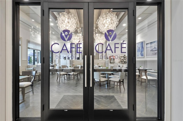 interior space featuring french doors and an inviting chandelier