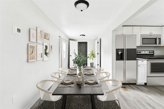 dining area with light wood-type flooring