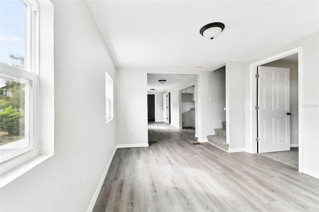 interior space featuring plenty of natural light and light hardwood / wood-style flooring