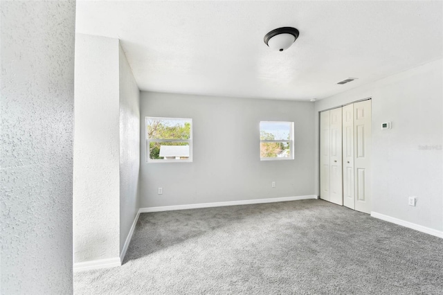 unfurnished room featuring carpet