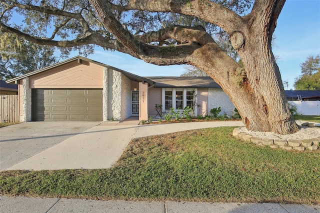 single story home with a garage and a front lawn