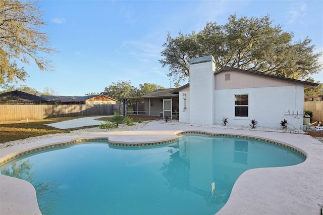 view of pool featuring a sunroom