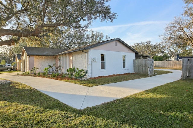 view of side of home featuring a lawn