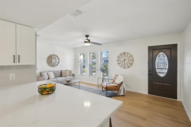 interior space featuring ceiling fan and light hardwood / wood-style flooring