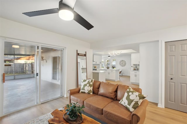 living room featuring ceiling fan and light hardwood / wood-style flooring