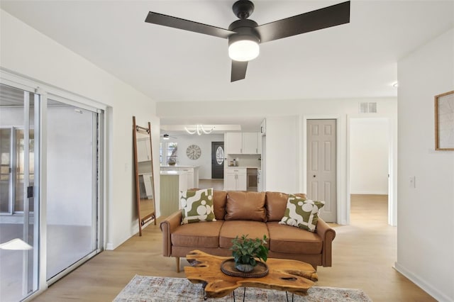 living room featuring light hardwood / wood-style floors and ceiling fan