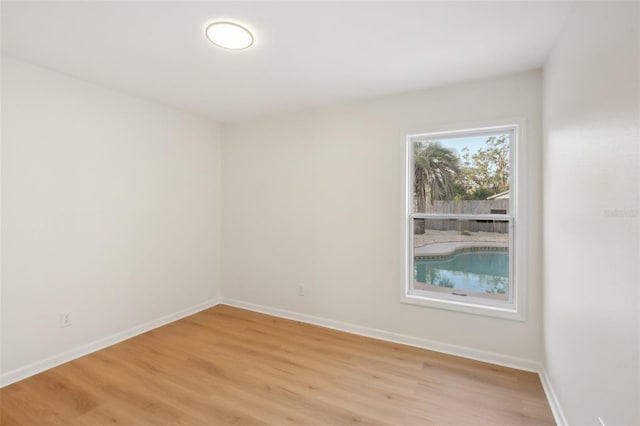 empty room with light hardwood / wood-style flooring