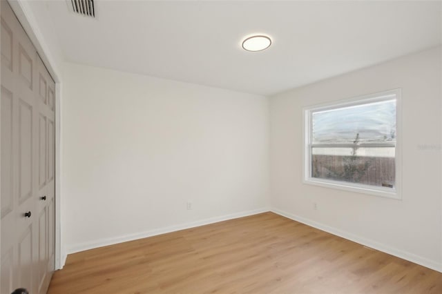 unfurnished bedroom with a closet and light hardwood / wood-style floors