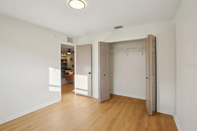 unfurnished bedroom featuring a closet and light wood-type flooring