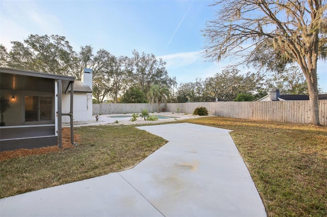 view of yard featuring a fenced in pool and a patio area