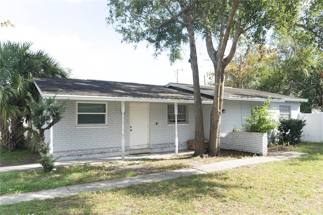 single story home with a porch and a front lawn