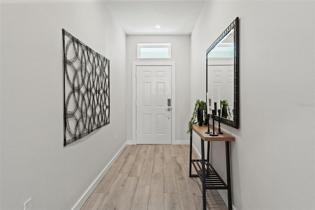 doorway to outside with light wood-type flooring