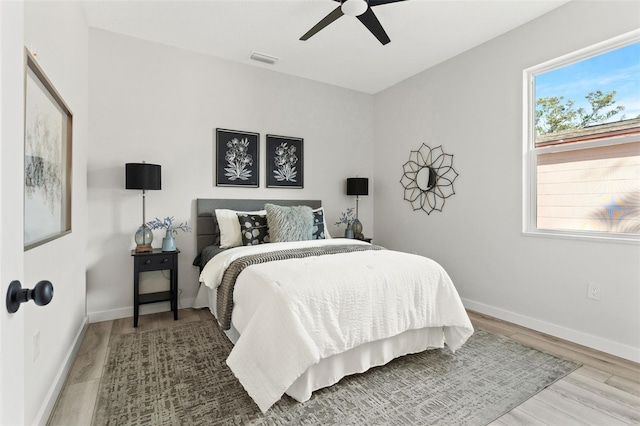 bedroom with hardwood / wood-style floors and ceiling fan