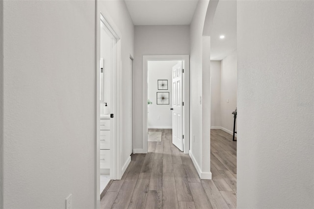 corridor with light hardwood / wood-style floors