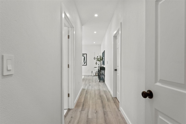 corridor with light hardwood / wood-style flooring