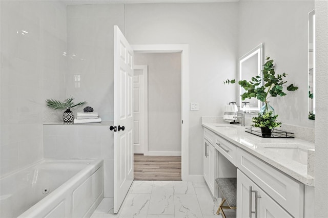 bathroom featuring vanity and a tub