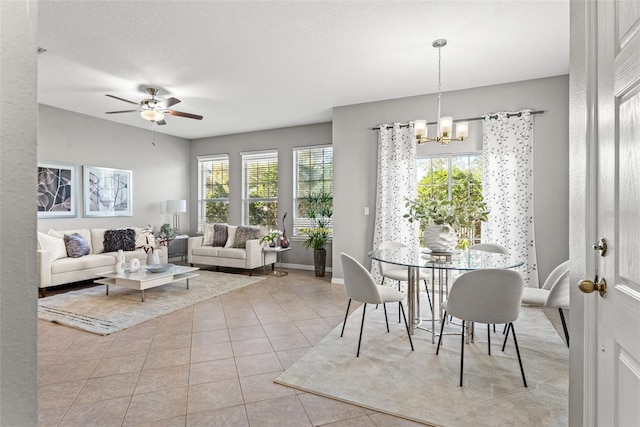 interior space featuring ceiling fan with notable chandelier and a textured ceiling