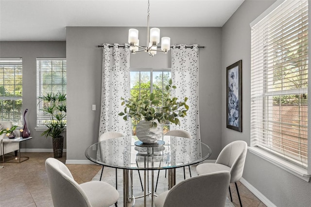 tiled dining room with a notable chandelier