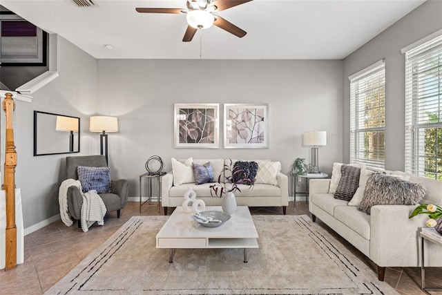 living room with tile patterned floors and ceiling fan