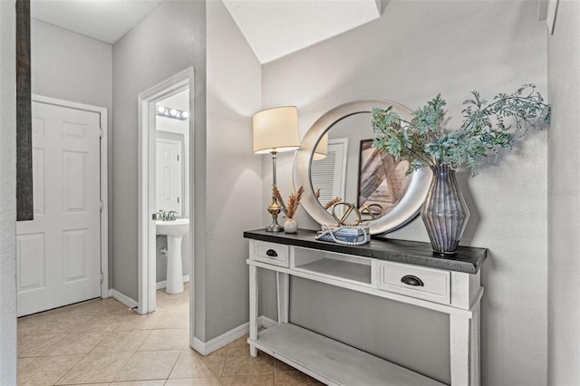 tiled entryway featuring sink