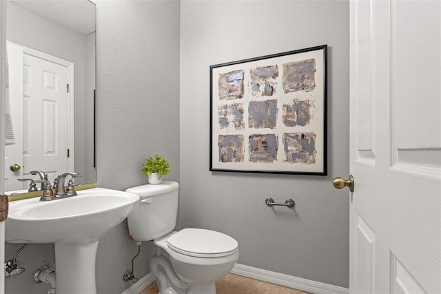 bathroom with tile patterned floors, sink, and toilet