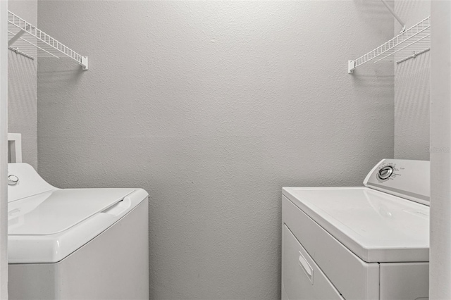 laundry area featuring washing machine and clothes dryer