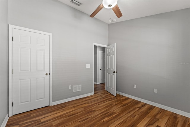 unfurnished bedroom with dark hardwood / wood-style floors and ceiling fan