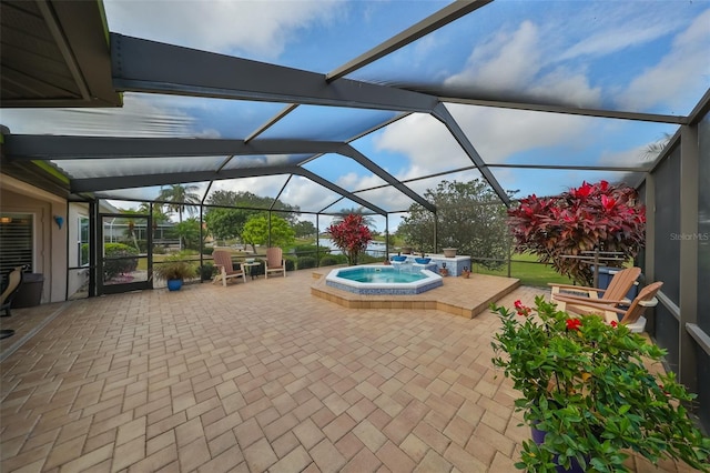 view of patio / terrace featuring glass enclosure and an in ground hot tub