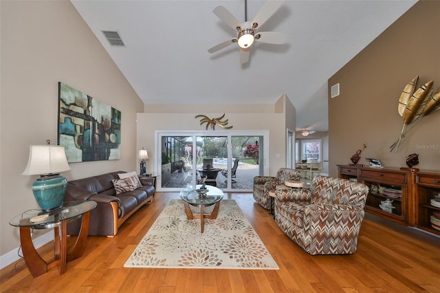 living room featuring ceiling fan, lofted ceiling, and light hardwood / wood-style floors