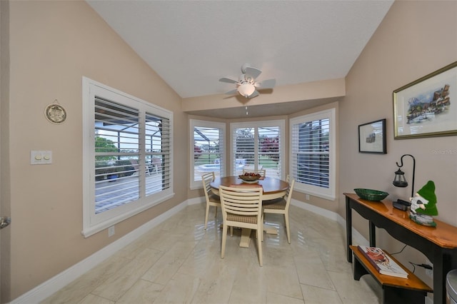 dining area with ceiling fan and lofted ceiling