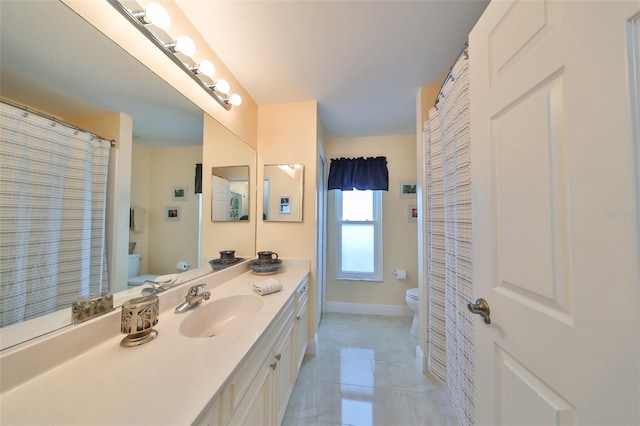 bathroom with toilet, tile patterned floors, and vanity