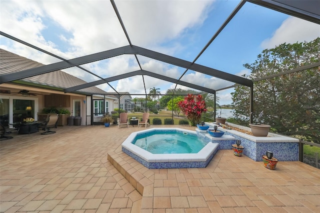 view of pool with an in ground hot tub, a lanai, and a patio