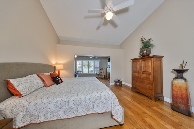 bedroom with ceiling fan, light hardwood / wood-style floors, and lofted ceiling