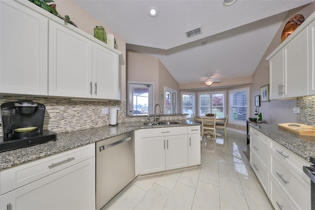 kitchen with vaulted ceiling, white cabinetry, dishwasher, and sink