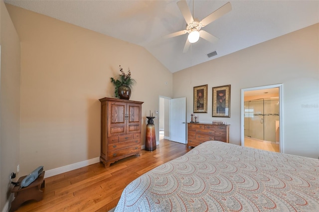 bedroom with ceiling fan, hardwood / wood-style flooring, ensuite bathroom, and vaulted ceiling