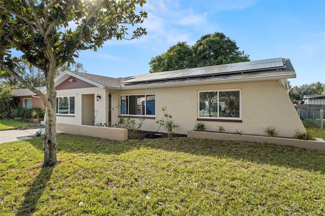 ranch-style house with a front lawn and solar panels