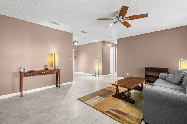 tiled living room with ceiling fan and a textured ceiling