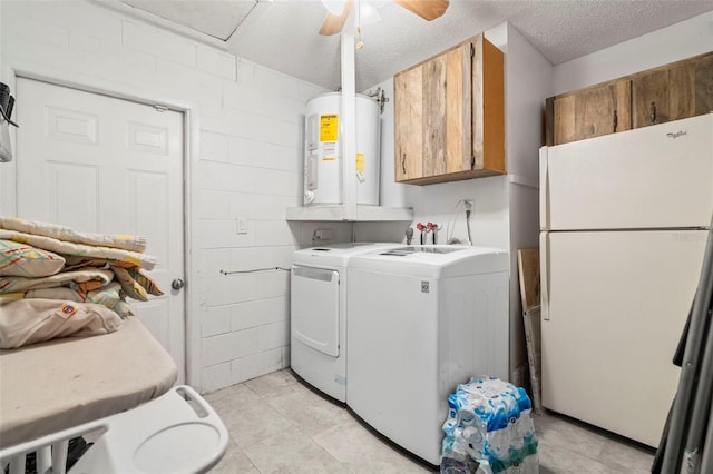 washroom featuring cabinets, ceiling fan, a textured ceiling, water heater, and washing machine and clothes dryer