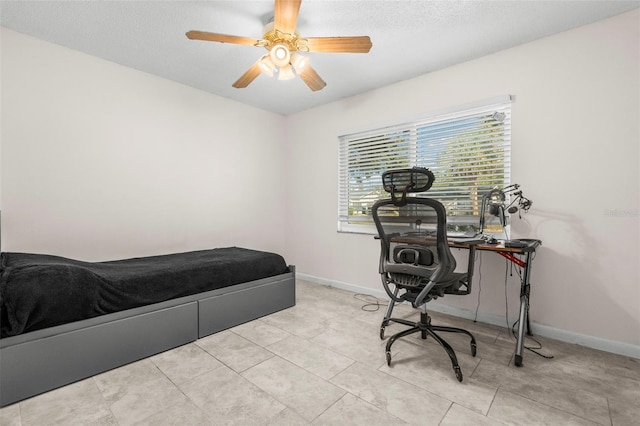 bedroom with ceiling fan and light tile patterned floors