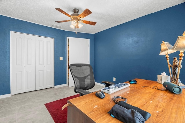 office featuring ceiling fan and a textured ceiling