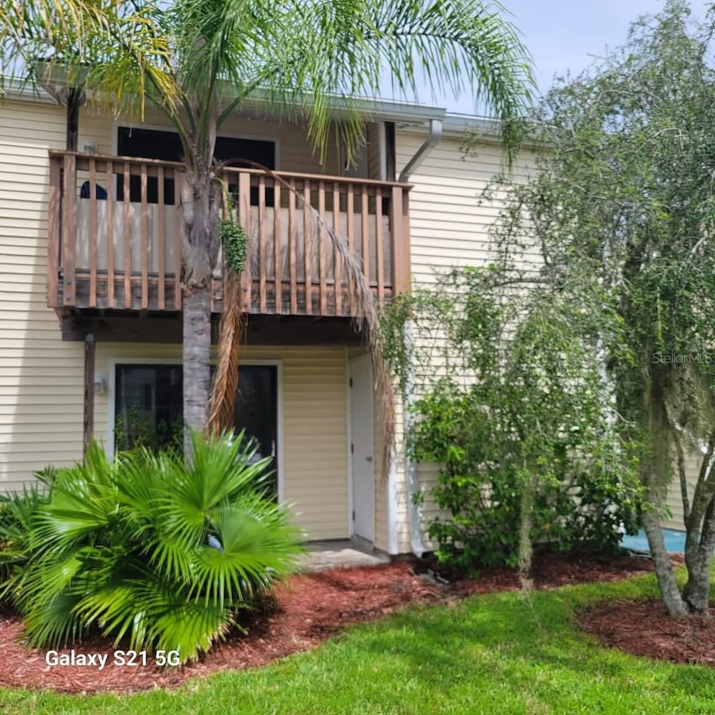 rear view of property featuring a balcony