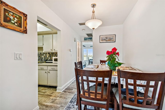 dining space featuring dark wood-type flooring