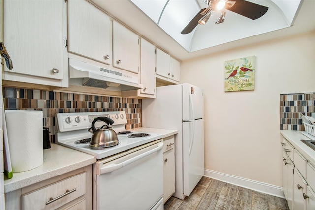 kitchen featuring decorative backsplash, ceiling fan, light wood-type flooring, and white appliances