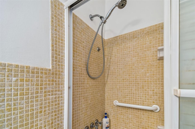 bathroom with tiled shower