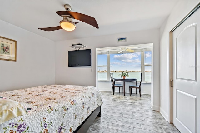 bedroom with ceiling fan and a closet