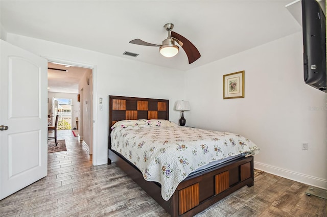 bedroom featuring hardwood / wood-style flooring and ceiling fan