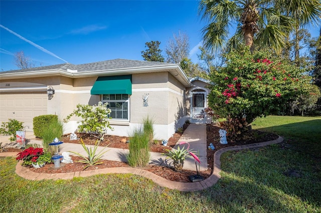 view of front of home with a front yard and a garage