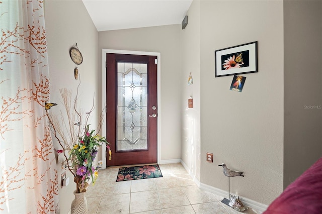 tiled foyer entrance featuring lofted ceiling